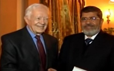 حقيقة فيديو كارتر مع مرسي والشاطر في مقر الإخوان