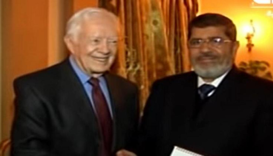 حقيقة فيديو كارتر مع مرسي والشاطر في مقر الإخوان